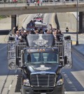 Dustin Brown of the Los Angeles Kings, holds up the Stanley Cup trophy while riding in a parade on the 110 freeway in downtown Los Angeles, Monday, June 16, 2014. The parade and rally were held to celebrate the Los Angeles Kings' second Stanley Cup championship in three seasons. (AP Photo/Mark J. Terrill)