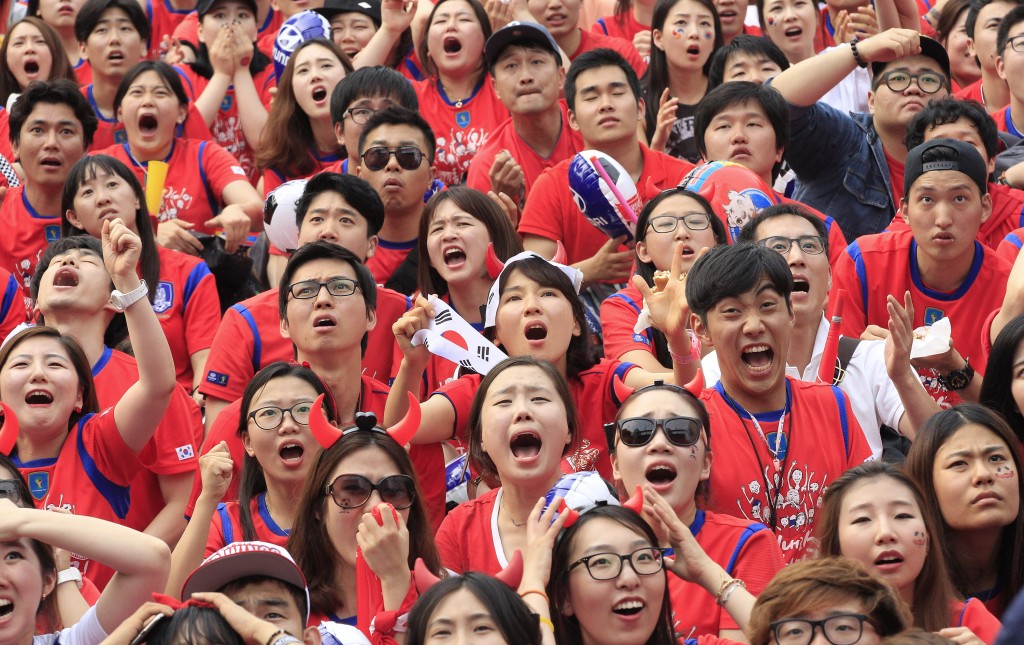 South Korean soccer fans react after Russian soccer team scored a goal against South Korea during the group H World Cup soccer match between Russia and South Korea, at a public viewing venue in Seoul, South Korea, Wednesday, June 18, 2014. (AP Photo/Ahn Young-joon)