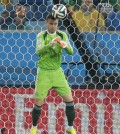 Russia's goalkeeper Igor Akinfeev gets embarrassed as the ball, kicked by South Korea's Lee Keun-ho, bounces off his head into the goal during the group H World Cup soccer match between Russia and South Korea at the Arena Pantanal in Cuiaba, Brazil, Tuesday, June 17, 2014.  (AP Photo/Ivan Sekretarev)