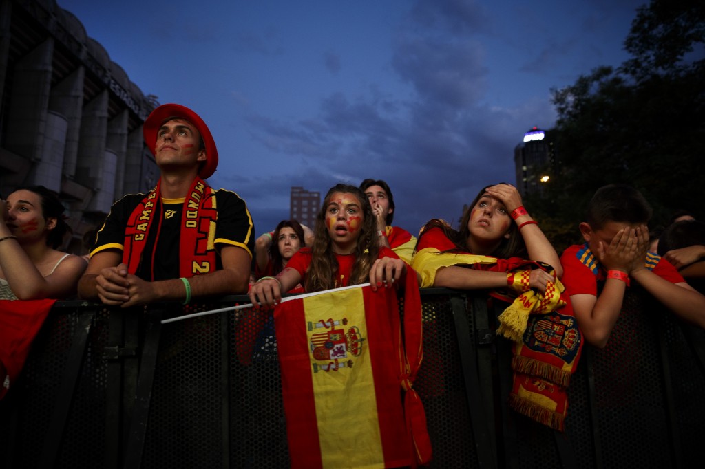 Spanish soccer fans watch on a giant display as the Netherlands soccer team wins the World Cup soccer match between Spain and Netherlands, in Madrid, Spain, Friday, June 13, 2014. (AP Photo/Daniel Ochoa de Olza)