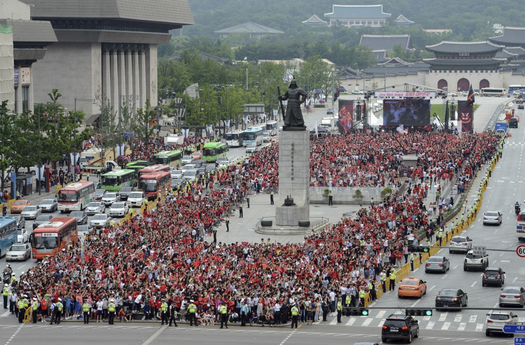 South Korean soccer fans gather to watch a live broadcast of 2014 Brazil World Cup Group H game between South Korea and Russia at a public viewing venue in Seoul, South Korea, Wednesday, June 18, 2014.(AP Photo/Yonhap, Shin June-hee)   