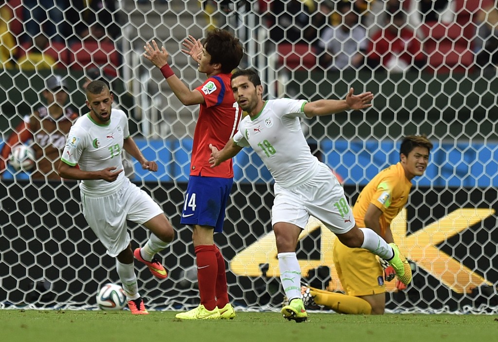 Algeria's Abdelmoumene Djabou celebrates after scoring his side's third goal during the group H World Cup soccer match between South Korea and Algeria at the Estadio Beira-Rio in Porto Alegre, Brazil, Sunday, June 22, 2014. (AP Photo/Martin Meissner)