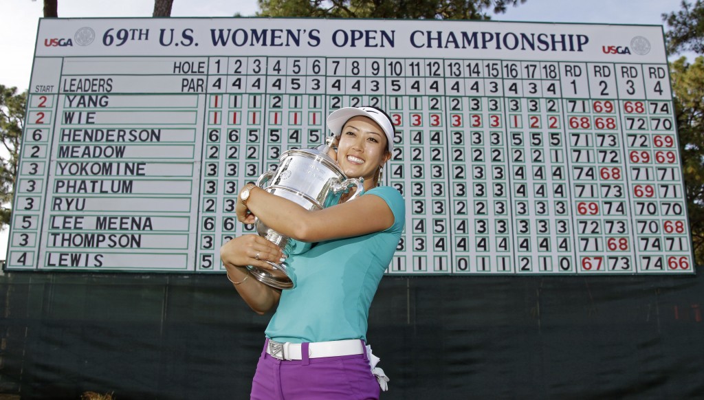Michelle Wie poses with the trophy after winning the U.S. Women's Open golf tournament in Pinehurst, N.C., Sunday, June 22, 2014. (AP Photo/Bob Leverone)