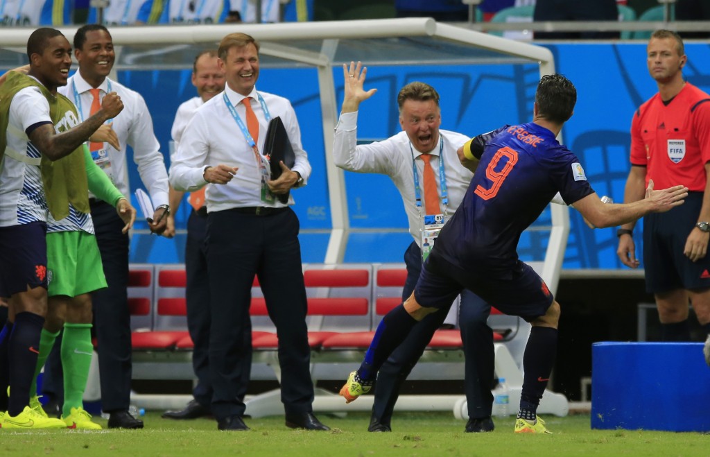 Netherlands' Robin van Persie celebrates with Netherlands' head coach Louis van Gaal after scoring a goal during the group B World Cup soccer match between Spain and the Netherlands at the Arena Ponte Nova in Salvador, Brazil, Friday, June 13, 2014. (AP Photo/Bernat Armangue)