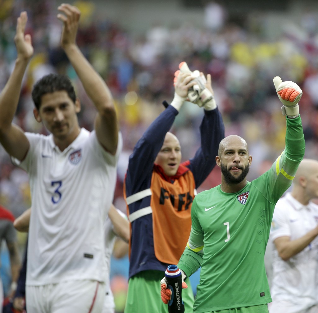 United States' goalkeeper Tim Howard (1) and his teammates celebrate after qualifying for the next World Cup round following their 1-0 loss to Germany during the group G World Cup soccer match between the USA and Germany at the Arena Pernambuco in Recife, Brazil, Thursday, June 26, 2014. (AP Photo/Ricardo Mazalan)