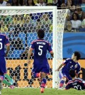 Colombia's Jackson Martinez, right, scores his side's third goal during the group C World Cup soccer match between Japan and Colombia at the Arena Pantanal in Cuiaba, Brazil, Tuesday, June 24, 2014. (AP Photo/Thanassis Stavrakis)