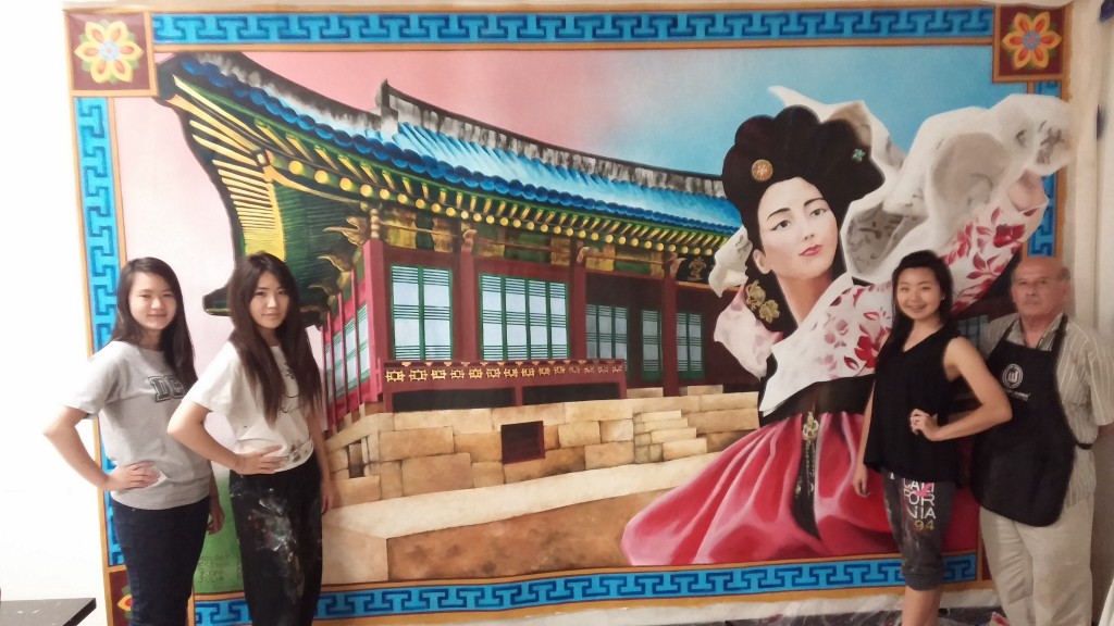 Yu-na Oh, Esther Park, Melody Lee and Art Department Director Manuel Gonzalez stand in front of the mural.