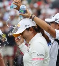 Park Inbee gets a victory shower from Lydia Ko after winning the Manulife Financial LPGA Classic golf tournament Sunday, June 8, 2014 in Waterloo, Ontario. (AP Photo/The Canadian Press, Dave Chidley)