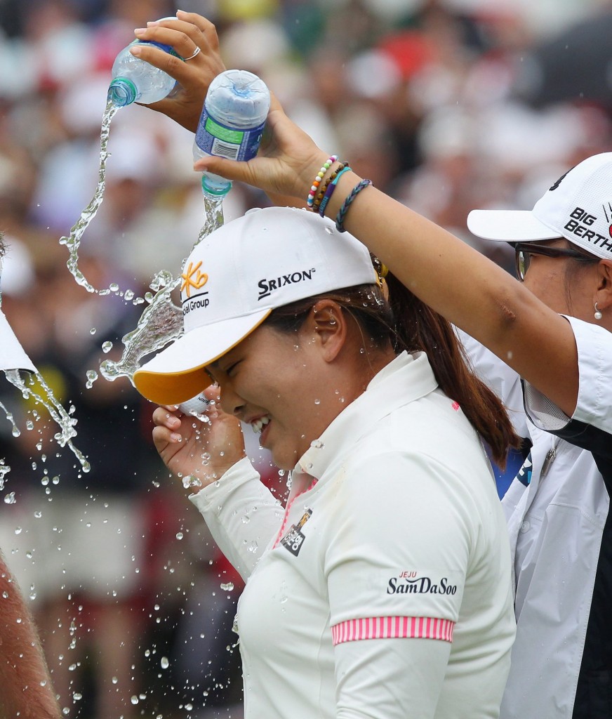 Park Inbee gets a victory shower from Lydia Ko after winning the Manulife Financial LPGA Classic golf tournament Sunday, June 8, 2014 in Waterloo, Ontario. (AP Photo/The Canadian Press, Dave Chidley)