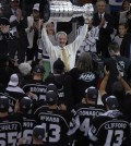 Los Angeles Kings head coach Darryl Sutter raises the Stanley Cup after the Kings beat the New York Rangers in Game 5 of the NHL Stanley Cup Final series Friday, June 13, 2014, in Los Angeles. The Kings won, 3-2. (AP Photo/Mark J. Terrill)