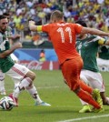 Netherlands' Arjen Robben, center, goes down to win the decisive penalty. (AP)