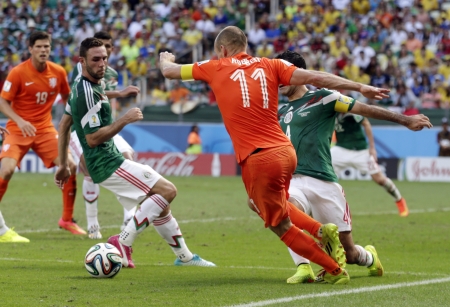 Netherlands' Arjen Robben, center, goes down to win the decisive penalty. (AP)