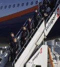 Members of Russia's national team deplane at the Sao Paulo International airport, Brazil, Sunday, June 8, 2014.  About 20,000 Russian fans are expected to show up in Brazil to support them. (AP Photo/Nelson Antoine)