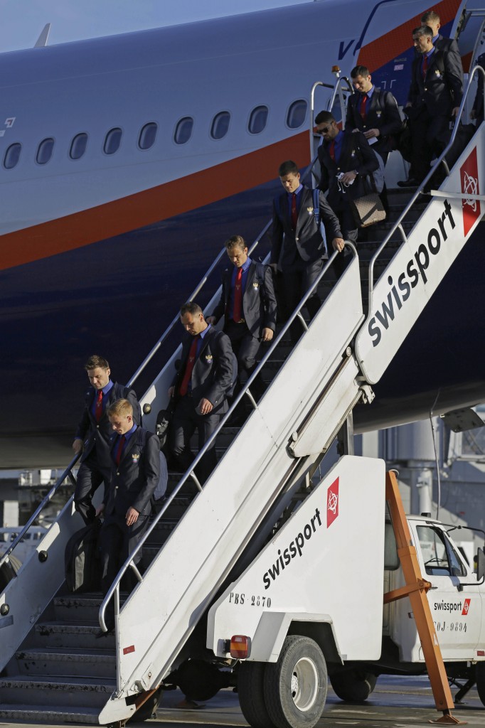 Members of Russia's national team deplane at the Sao Paulo International airport, Brazil, Sunday, June 8, 2014.  About 20,000 Russian fans are expected to show up in Brazil to support them. (AP Photo/Nelson Antoine)
