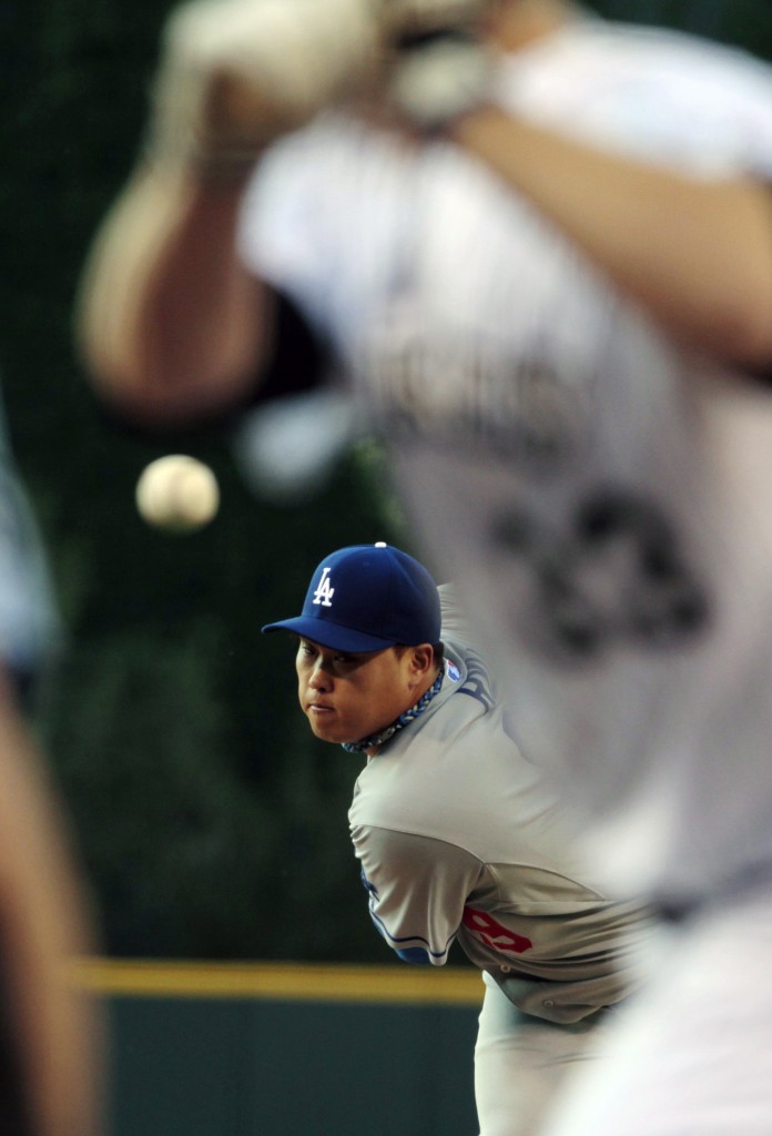Los Angeles Dodgers starting pitcher Hyun-Jin Ryu (99) delivers a pitch against the Colorado Rockies in the  first inning of a baseball game in Denver on Friday, June 6, 2014. (AP Photo/Joe Mahoney)