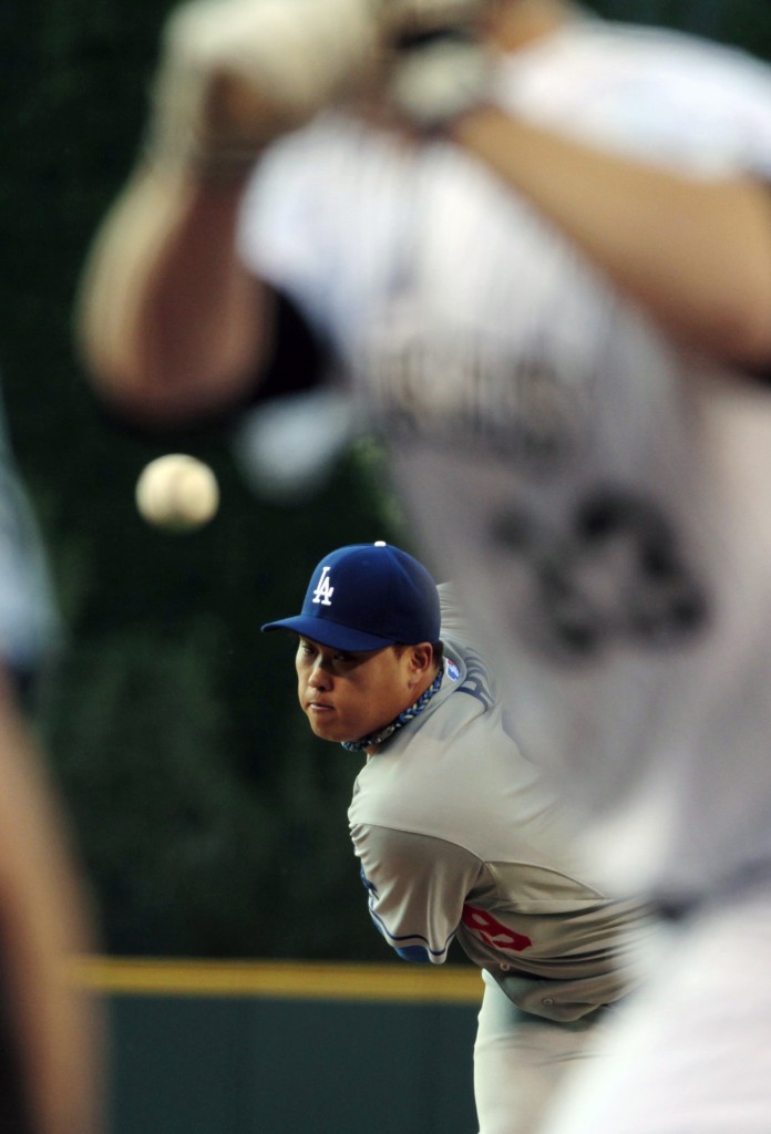 Los Angeles Dodgers starting pitcher Hyun-Jin Ryu (99) delivers a pitch against the Colorado Rockies in the first inning of a baseball game in Denver on Friday, June 6, 2014. (AP Photo/Joe Mahoney)