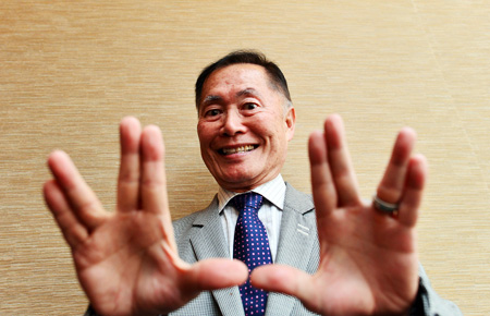 Actor George Takei gives the "Vulcan salute" popularized by the original "Star Trek" television series, during an interview last Friday at the Westin Chosun hotel in downtown Seoul. (Shim Hyun-cheol / The Korea Times)