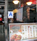 A Korean restaurant in New York City displays its "A" inspection grade on its front window.