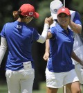 Na Yeon Choi, left, and I.K. Kim, both of South Korea, celebrate a birdie on the first hole during the third round of the International Crown golf tournament Saturday, July 26, 2014, in Owings Mills, Md.(AP Photo/Gail Burton)