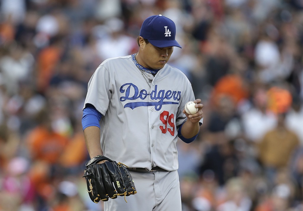 Los Angeles Dodgers pitcher Hyun-Jin Ryu looks at the ball against the Detroit Tigers in the second inning of a baseball game in Detroit, Tuesday, July 8, 2014. (AP Photo/Paul Sancya)