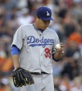 Los Angeles Dodgers pitcher Hyun-Jin Ryu looks at the ball against the Detroit Tigers in the second inning of a baseball game in Detroit, Tuesday, July 8, 2014. (AP Photo/Paul Sancya)