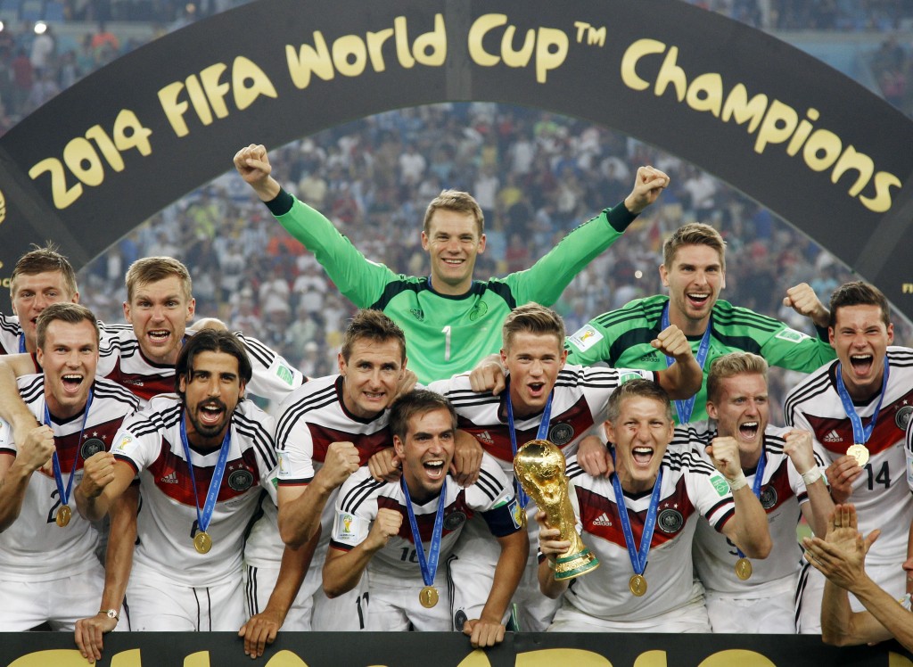 German players celebrate with the trophy after the World Cup final soccer match between Germany and Argentina at the Maracana Stadium in Rio de Janeiro, Brazil, Sunday, July 13, 2014. Germany won the match 1-0. (AP Photo/Matthias Schrader)