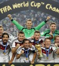 German players celebrate with the trophy after the World Cup final soccer match between Germany and Argentina at the Maracana Stadium in Rio de Janeiro, Brazil, Sunday, July 13, 2014. Germany won the match 1-0. (AP Photo/Matthias Schrader)