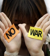A South Korean students shows her palms with signs during a rally against the Israeli military operations in Gaza and the West Bank and wish for peace near the Israel Embassy in Seoul, South Korea, Wednesday, July 30, 2014. (AP Photo/Lee Jin-man)