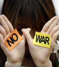 A South Korean students shows her palms with signs during a rally against the Israeli military operations in Gaza and the West Bank and wish for peace near the Israel Embassy in Seoul, South Korea, Wednesday, July 30, 2014. (AP Photo/Lee Jin-man)