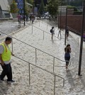 People walk down a stairway leading to a parking structure across from Pauley Pavilion on the UCLA campus after flooding from a broken 30-inch water main under nearby Sunset Boulevard inundated a large area of the campus in the Westwood section of Los Angeles, Tuesday, July 29, 2014. The 30-inch (75-centimeter)  93-year-old pipe that broke made a raging river of the street and sent millions of gallons (liters) of water across the school's athletic facilities, including the famed floor of Pauley Pavilion, the neighboring Wooden Center and the Los Angeles Tennis Center, and a pair of parking structures that took the brunt of the damage. (AP Photo/Mike Meadows)