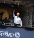 Broadcaster Vin Scully acknowledges the crowd at Dodger Stadium during a baseball game between the Los Angeles Dodgers and the Atlanta Braves on Tuesday, July 29, 2014, in Los Angeles. The Dodgers announced that Scully will remain with the team for the 2015 season. (AP Photo/Jae C. Hong)