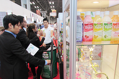 Customers sample a Korean aloe beverage at the Fancy Food Show held in New York in June.