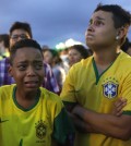 Brazil soccer fans cry as they watch their team get beat during a live telecast of the semi-finals World Cup soccer match between Brazil and Germany, inside the FIFA Fan Fest area on Copacabana beach in Rio de Janeiro, Brazil, Tuesday, July 08, 2014. (AP Photo/Leo Correa)