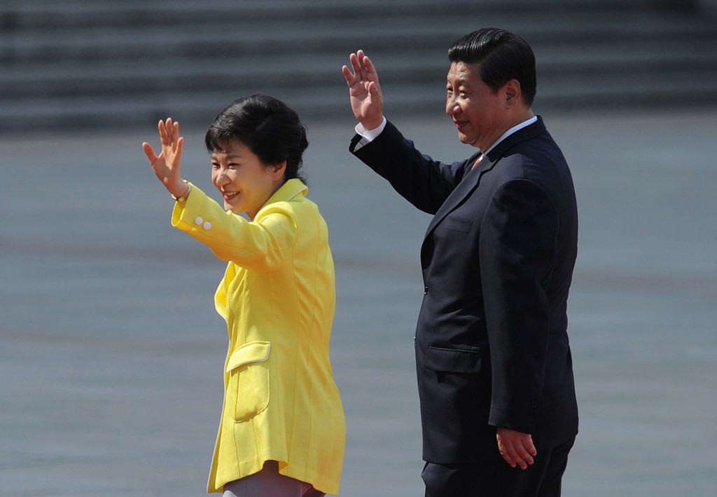 South Korean President Park Geun-hye, left, and Chinese President Xi Jinping wave during a welcoming ceremony outside the Great Hall of the People in Beijing Thursday, June 27, 2013. The Chinese and South Korean presidents reaffirmed close ties between their nations Thursday at a Beijing summit that brings together North Korea's archrival and its biggest ally, ratcheting up pressure on Pyongyang to rejoin nuclear disarmament talks. (AP Photo/Wang Zhao, Pool)