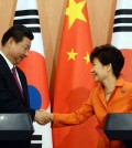 President Park Geun-hye and Chinese President Xi Jinping shake hands during a press conference after a summit at Cheong Wa Dae, Thursday. (Yonhap)