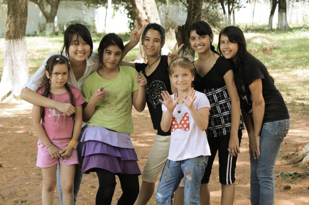 Hana Kim with local kids during a volunteer trip to Paraguay.