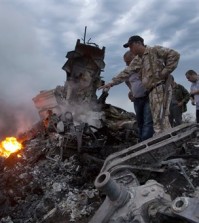 People inspect the crash site of a passenger plane near the village of Grabovo, Ukraine, Thursday, July 17, 2014.  Koreans experienced similar attack some three decades ago, when Soviet forces shot down Korean Air Lines Flight 007.  (AP Photo/Dmitry Lovetsky)