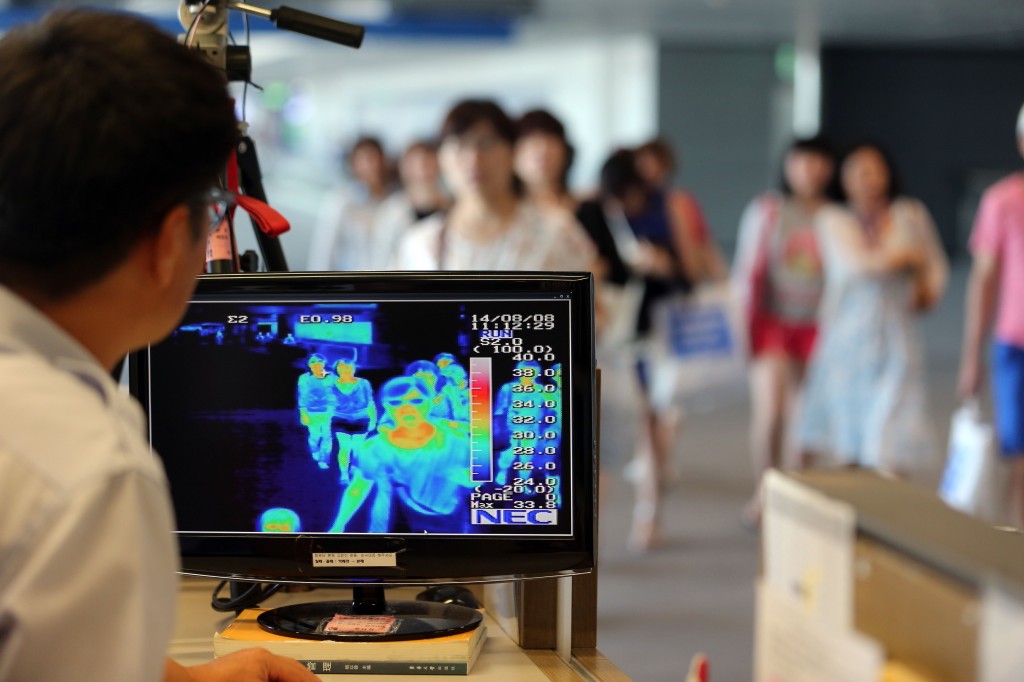 A thermal camera monitor shows the body temperature of passengers arriving from overseas against possible infections of Ebola virus at the Incheon International Airport in Incheon, South Korea, Friday, Aug. 8, 2014. South Korea has been stepping up monitoring of its citizens returning from trips to West Africa and other areas affected by the deadly Ebola virus. (Yonhap)