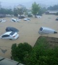 Cars are afloat in a flooded area in Geumjeong, Busan, Monday. Heavy rain hit the southern part of the country, causing flash floods, landslides, and suspension of subway service in some areas. (Yonhap)