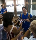 Sung Woo Lee, center, speaks to the local media after arriving at Kansas City International Airport Tuesday, Aug. 5, 2014. Lee is a Kanas City Royals fan from South Korea and came to Kansas City to see his first Royals game. He will see five games and throw out the first pitch on Monday (AP Photo/The Kansas City Star, Brian Davidson)