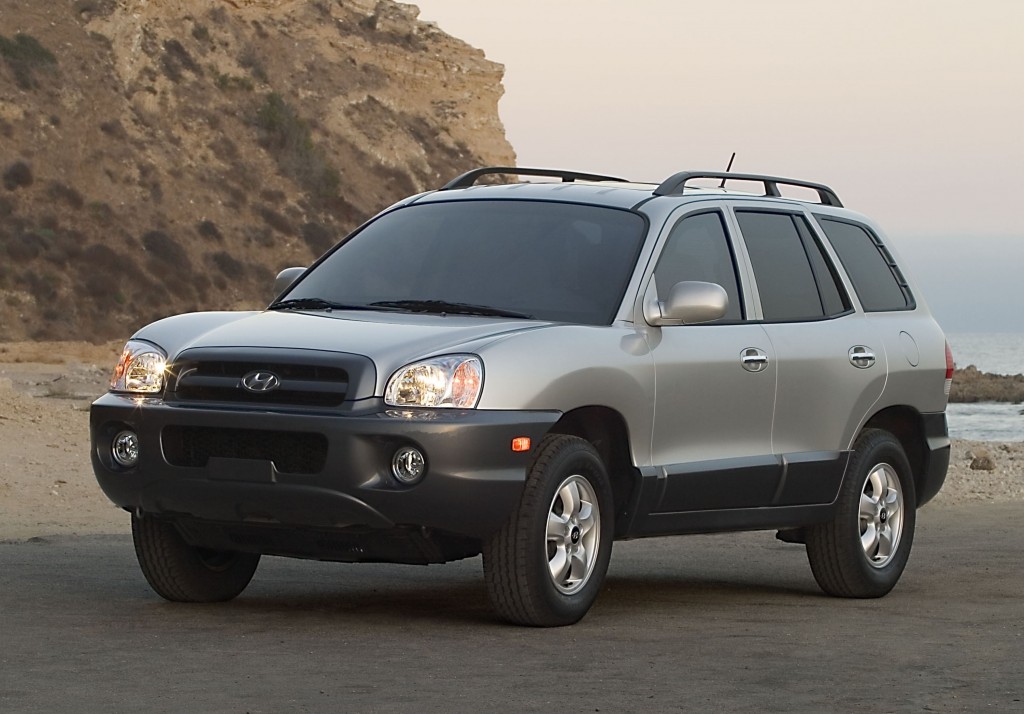 This undated photo provided by Hyundai shows the 2005 Hyundai Santa Fe. Hyundai is recalling more than 419,000 cars and SUVs to fix suspension, brake and oil leak problems. The biggest of three recalls posted Friday, Aug. 1, 2014, by U.S. safety regulators is of 225,000 Santa Fe SUVs from 2001-2006 to replace front coil springs that can rust and crack in cold-weather states. The springs can fracture and make contact with a tire, potentially causing a crash. (AP Photo/Hyundai)