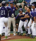 Seoul's Hae Chan Choi (21) is greeted by teammates after hitting a two-run home run off Tokyo pitcher Takuma Takahashi in the second inning of a International semi-final baseball game against Tokyo at the Little League World Series tournament in South Williamsport, Pa., Wednesday, Aug. 21, 2013. (AP Photo/Gene J. Puskar)