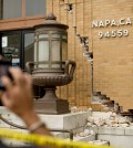 A man photographs damage to a post office in Napa, Calif., following an earthquake Sunday, Aug. 24, 2014. A large earthquake caused significant damage and left at least three critically injured in California's northern Bay Area early Sunday, igniting fires, sending at least 87 people to a hospital, knocking out power to tens of thousands and sending residents running out of their homes in the darkness (AP Photo/Noah Berger)