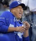 Los Angeles Dodgers' Hyun-Jin Ryu, of South Korea, reacts as he is sprayed with water by a teammate prior to a baseball game against the Chicago Cubs, Friday, Aug. 1, 2014, in Los Angeles. (AP Photo/Mark J. Terrill)