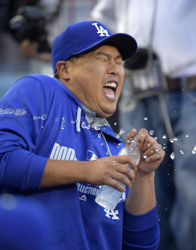 Los Angeles Dodgers' Hyun-Jin Ryu, of South Korea, reacts as he is sprayed with water by a teammate prior to a baseball game against the Chicago Cubs, Friday, Aug. 1, 2014, in Los Angeles. (AP Photo/Mark J. Terrill)