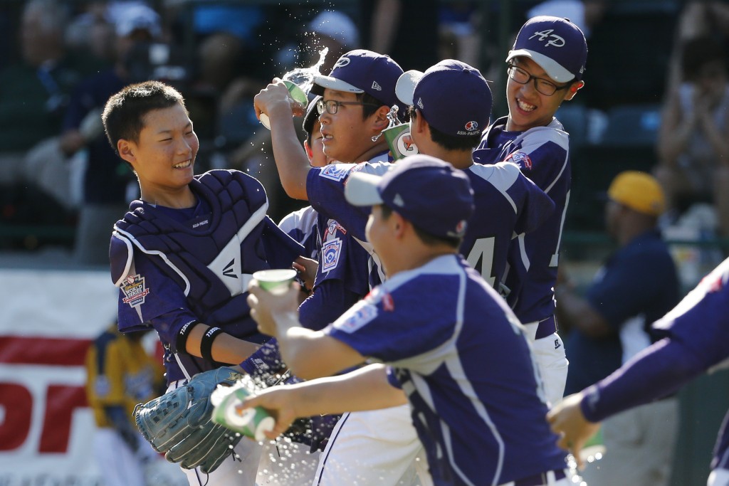 South Korea's Hae Chan Choi, center, celebrates with teammates after getting the final out of a 8-4 win in the Little League World Series championship baseball game against Chicago in South Williamsport, Pa., Sunday, Aug. 24, 2014. (AP Photo/Gene J. Puskar)