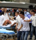 Medical staff move a severely burnt victim of an explosion at an eastern Chinese automotive parts factory from a hospital in the city of Kunshan, Jiangsu province, Saturday, Aug. 2, 2014 to a Shanghai hospital which is better equipped to handle severe burns. Dozens of people were killed Saturday by the explosion at the factory that supplies General Motors, state media reported. (AP Photo)