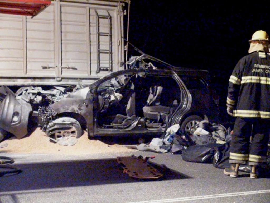 Firefighters inspect the car of Emanuel Bergoglio, nephew to Pope Francis, which crashed with a truck in James Craik, Argentina, early Tuesday, Aug. 19, 2014. Emanuel Bergoglio was seriously wounded as two young great-nephews of Pope Francis as well as their mother, the wife of the pope's nephew, were killed in the crash, according to the Vatican and a local police official. (AP Photo/DyN)