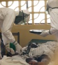 In this 2014 photo provided by the Samaritan's Purse aid organization, Dr. Kent Brantly, left, treats an Ebola patient at the Samaritan's Purse Ebola Case Management Center in Monrovia, Liberia. On Saturday, July 26, 2014, the North Carolina-based aid organization said Brantly tested positive for the disease and was being treated at a hospital in Monrovia. (AP Photo/Samaritan's Purse)