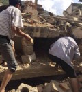 In this photo taken by cellphone and released by China's Xinhua News Agency, men at rubbles of buildings look for survivors after an earthquake in Ludian County of Zhaotong City in southwest China's Yunnan Province Sunday, Aug. 3, 2014. A strong earthquake rattled southwest China on Sunday, knocking out communication and power lines and causing people to rush out of buildings, but there were no immediate reports of injuries. (AP Photo/Xinhua/Hu Chao)